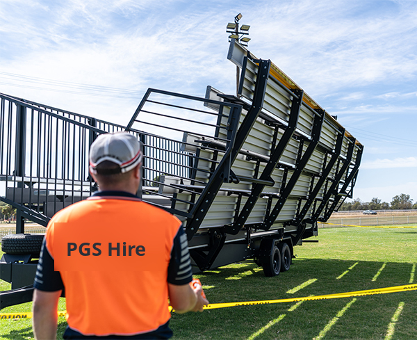 PGS Hire crew guiding the grandstand fold-out on site